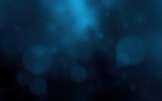 A serene underwater atmosphere with blue hues and softly glowing particles in a tranquil setting photo