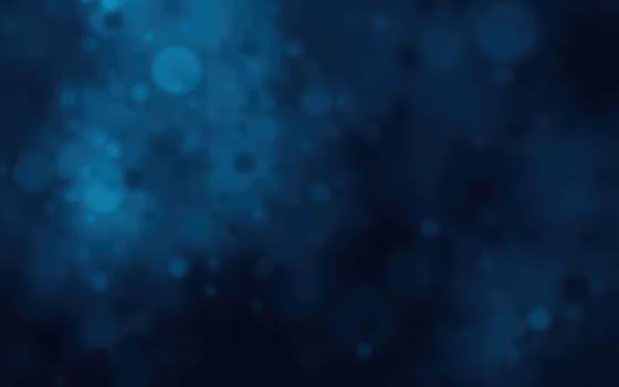 Swirling blue abstract background with soft glowing particles and bokeh effects in a digital design photo