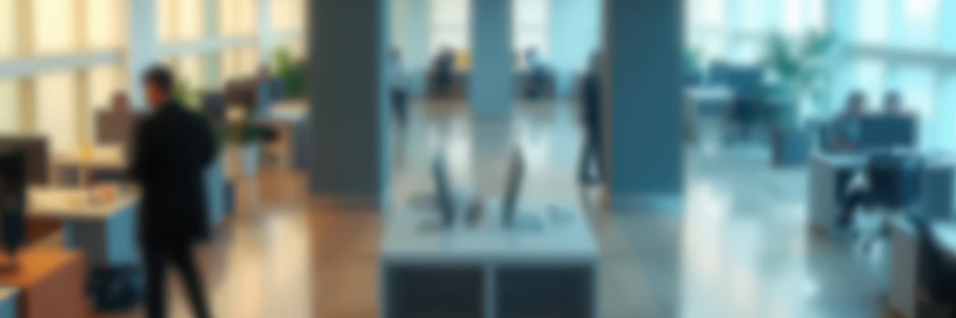 Modern office environment bustling with professionals engaged in various tasks during the daytime photo