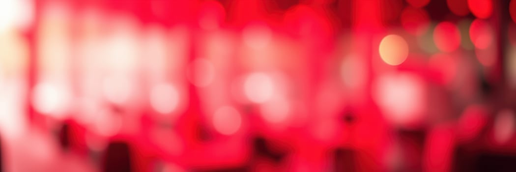 Vibrant red lighting creates an energetic atmosphere in a bustling urban cafe during evening hours photo