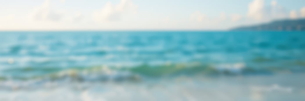 Waves gently roll onto a sunlit beach at midday, creating a tranquil and serene coastal atmosphere for relaxation photo