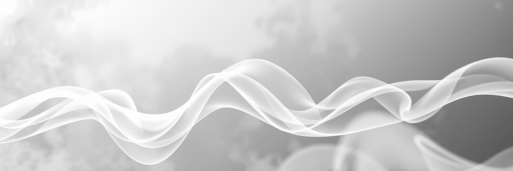 Ethereal white smoke gently swirls against a blurred gray background creating a dreamy atmosphere photo