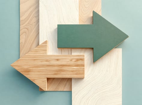 intersecting wooden arrows on pale blue background photo