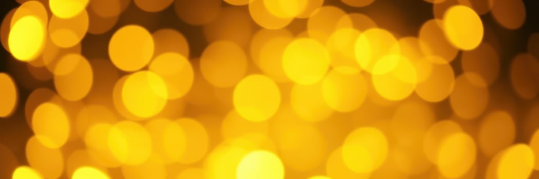 Bright golden bokeh lights create a warm and inviting atmosphere during a festive evening celebration photo