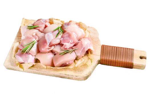 raw chicken fillet cut into cubes with spices. Isolated on white background. Top view. photo