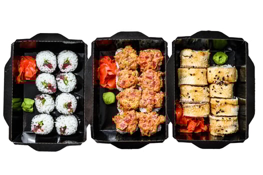 The sushi rolls in the delivery package, ordered in sushi take-out restaurant. Isolated on white background. Top view. photo