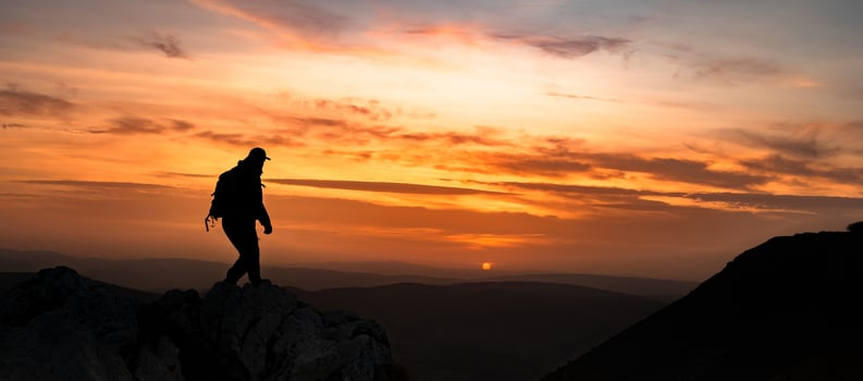 A man traveler solo hiking top of the mountain adventure travel. photo