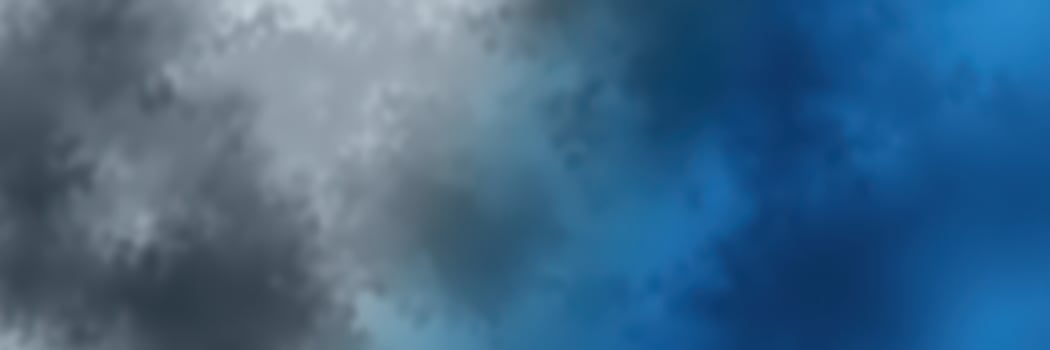 Clouds shift in various shades of blue and gray during a late afternoon sky transition over a serene landscape photo