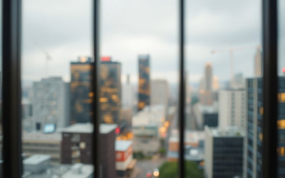 Urban skyline view through a window with blurred foreground and overcast weather in a bustling city photo