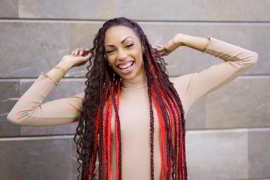 A Stylish Young Woman with Long, Beautifully Braided Hair in a Vibrant Urban Setting photo