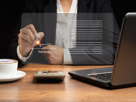 Electronic signature. A businesswoman uses a pen to sign electronic documents on digital documents on a virtual screen photo