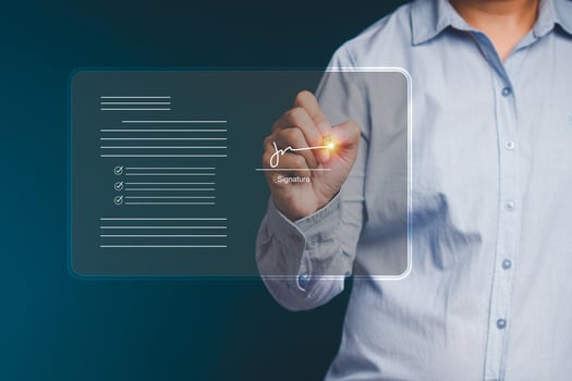 Electronic signature concept. A businessman uses a pen to sign electronic documents on digital documents on a virtual screen photo