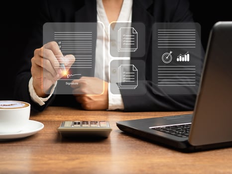 A businesswoman uses a pen to sign electronic documents on digital documents on a virtual screen. Electronic signature and paperless office concept photo