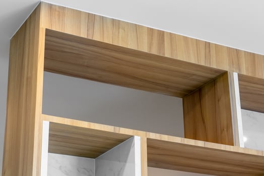 A wooden shelf with shelves and a white marble top photo
