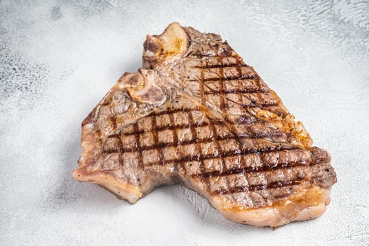 Grilled T-bone or Porterhouse beef meat Steak. White background. Top view. Copy space photo
