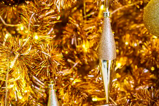 Luxurious Golden Christmas Tree Adorned with Sparkling Ornaments for the Holidays photo