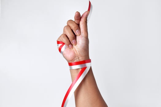 Greetings of love with two fingers circled by a red and white ribbon photo