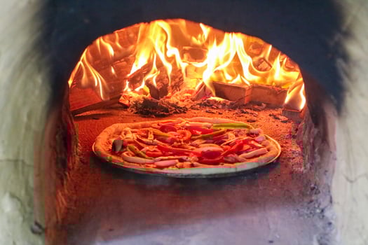 wide cover photo image of traditional wood fired oven pizza fresh baked brick inside pizzeria