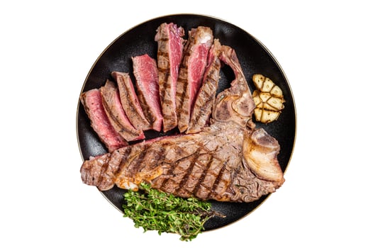 Grilled Medium rare Porterhouse, T-Bone Steak sliced in a plate. Isolated on white background. photo