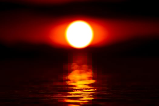 Sunset sky with big sun mirror on the water in the dark sky. photo
