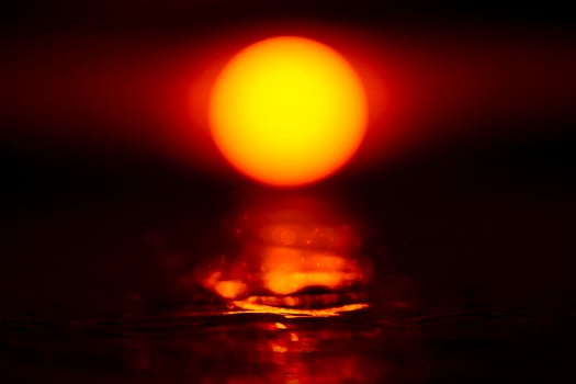 Sunset sky with big sun mirror on the water in the dark sky. photo