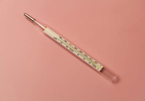 Clinical Thermometer put on pastel background photo