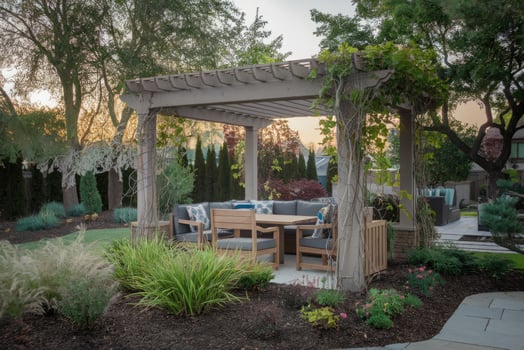 Comfortable pergola providing shade in luxurious backyard during sunset photo