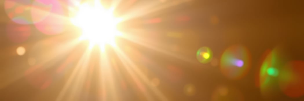 Bright sunlight beams through a clear sky, creating a vibrant glow and illuminating the surroundings in the early morning hours photo