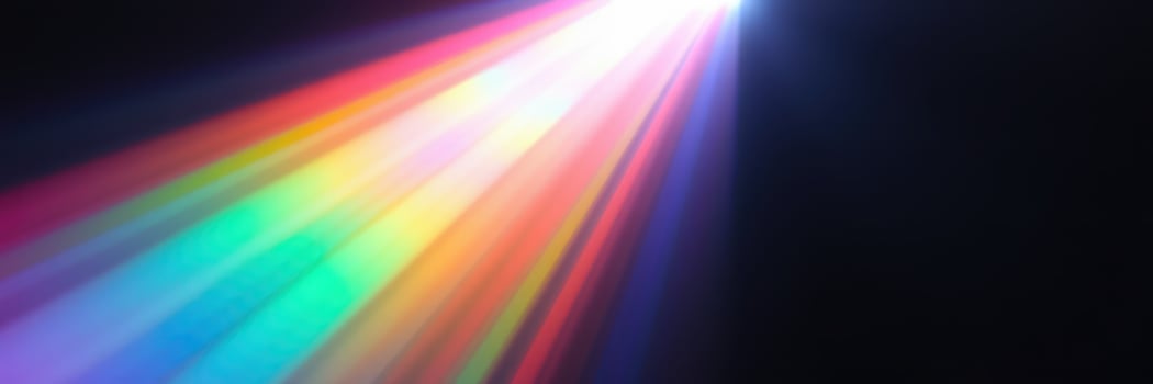 Colorful light beam illuminating darkness while creating a vibrant display of rainbow hues photo