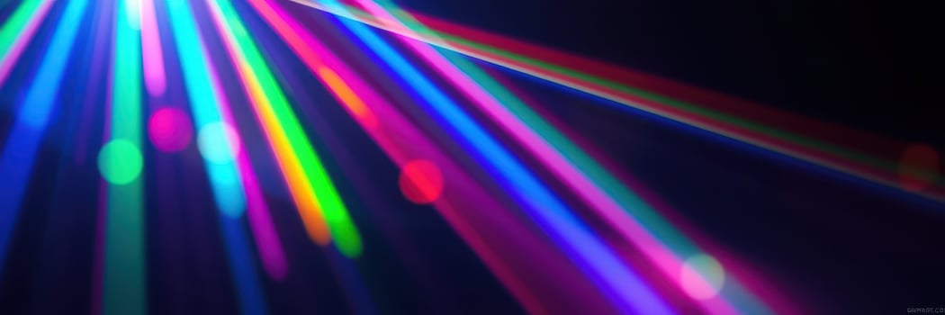 Colorful beams of light create a vibrant atmosphere in a dark space during a lively event photo