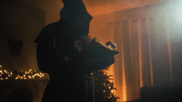 Silhouette Religious Monk Reads Bible Book In Front Of Christmas Tree At Night photo