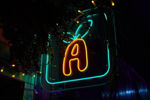 A Beautiful and Vibrant Neon Sign Featuring the Letter A Illuminated at Night in the City photo