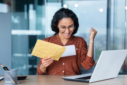 Happy hispanic business woman received letter from bank notification in envelope, happy business woman reading and reaching for good news, working inside office. photo
