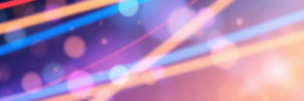 Colorful abstract lights create a vibrant backdrop during a lively nighttime event in a urban setting photo