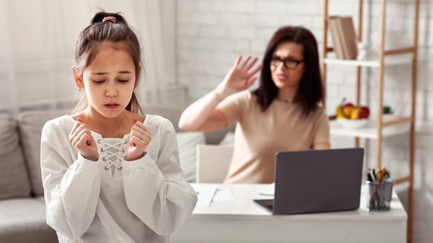 Stay home family problems. Business mom shouting at her unhappy daughter during her work in home office photo