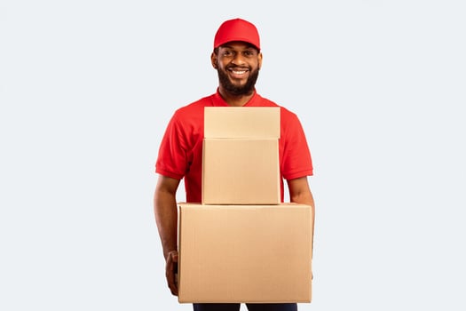 Express Delivery. Black Courier Man Holding Cardboard Boxes And Parcels Standing On Yellow Studio Background Delivering Goods From Online Store. photo