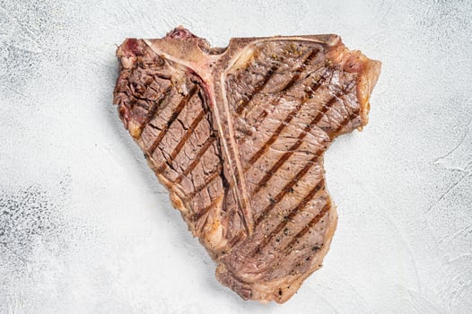 Grilled T-bone or Porterhouse beef meat Steak. White background. Top view. Copy space photo