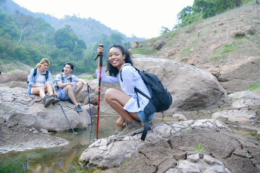 A group of friends going hiking in the streams of the tropical forest area. photo