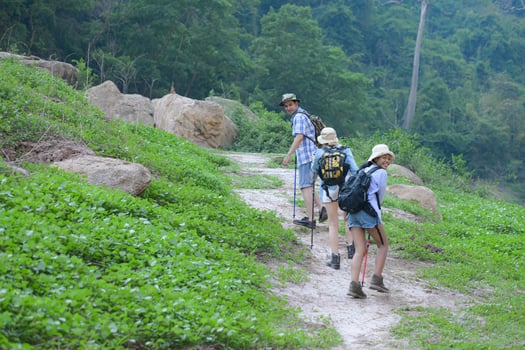 A group of friends going hiking in the streams of the tropical forest area. photo