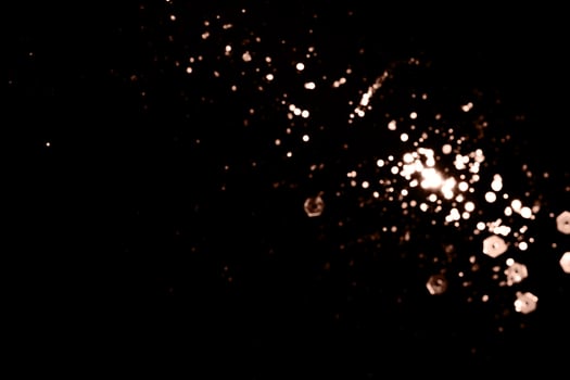 Blurry garland lights on a dark background. Festive Christmas and New Year background. Soft focus. Image toned in color of 2025 year - Mocha Mousse photo