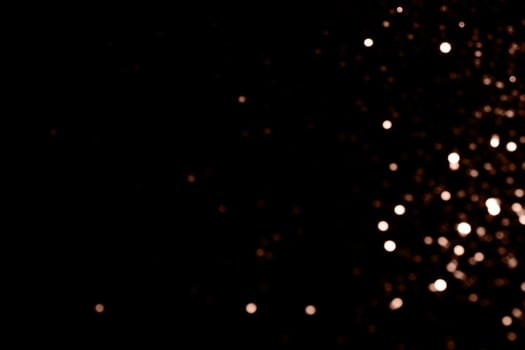 Blurry garland lights on a dark background. Festive Christmas and New Year background. Soft focus. Image toned in color of 2025 year - Mocha Mousse photo