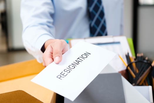 Employee handing in a resignation letter during a workplace transition. photo