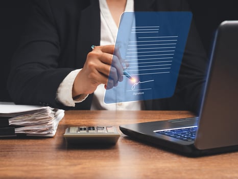 Electronic signature. A businesswoman uses a pen to sign electronic documents on digital documents on a virtual screen photo