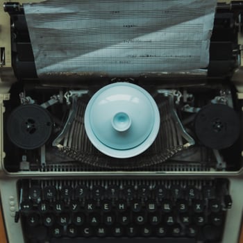 A vintage typewriter paired harmoniously with a decorative dish, evoking nostalgia photo