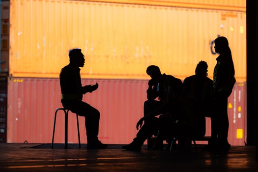 Group of warehouse employee talking and meeting comfortably during work, Silhouette concept. photo