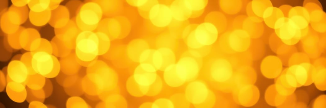 Bright golden bokeh lights create a warm and festive atmosphere in a celebration setting photo