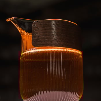 An Elegant Glass Pitcher Adorned with Warm Lighting that Enhances Aesthetic Appeal photo