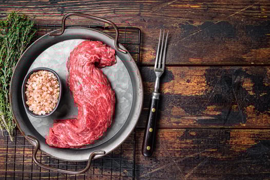 Raw uncooked Machete beef meat steak, skirt steak. Wooden background. Top view. Copy space photo
