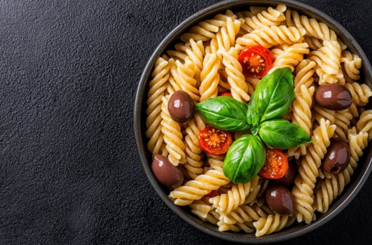 Delicious pasta dish with tomatoes and olives photo