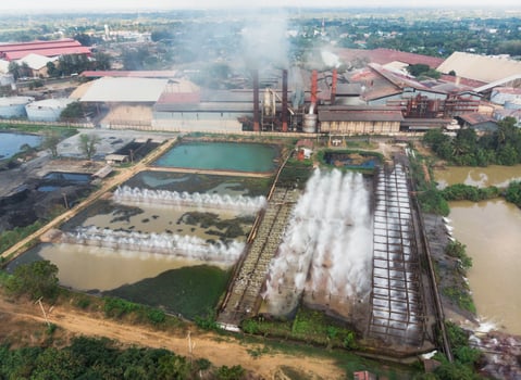 Industry factory manufacturing with pond of wastewater treatment photo